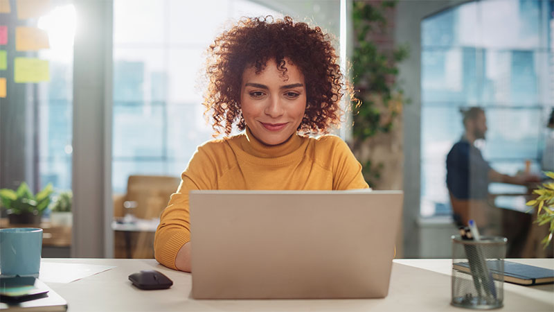 woman smiling in laptop screen