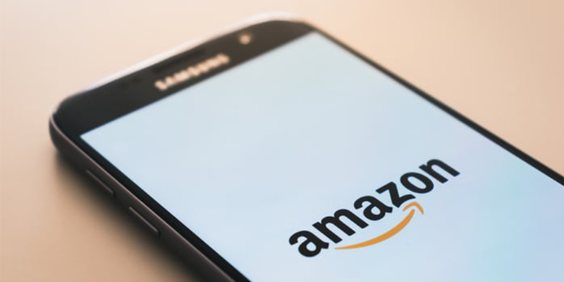 mobile phone with Amazon logo on screen
