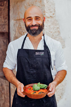 Chef Domenico Bianco holding Italian food