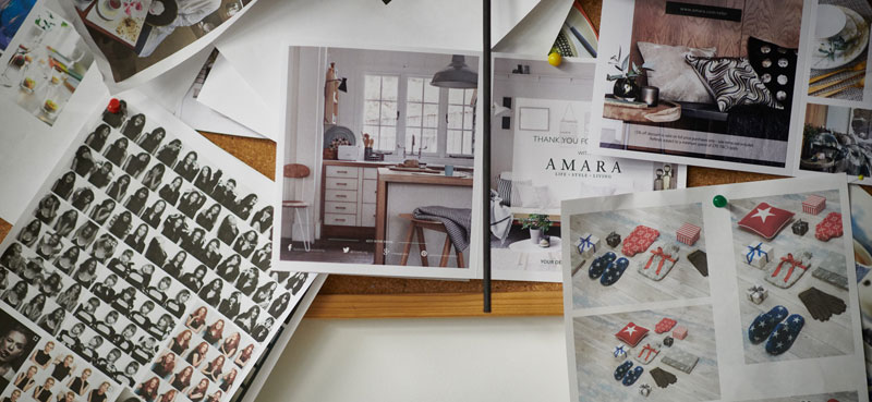 Amara catalogues and product photography spread out on a desk