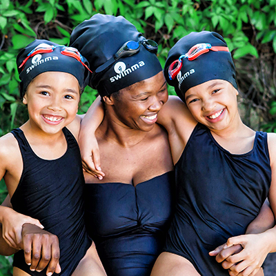 Mother and two daughters in swimming attire