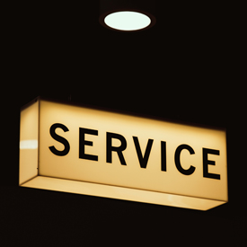Illuminated lightbox displaying the word 'Service'