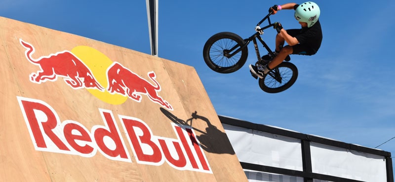 Stunt rider on Red Bull branded cycle ramp
