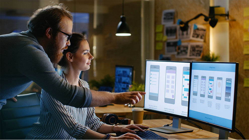 man pointing at computer screen