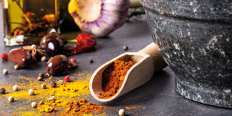 Cooking tool with spices inside with a black bowl on the side