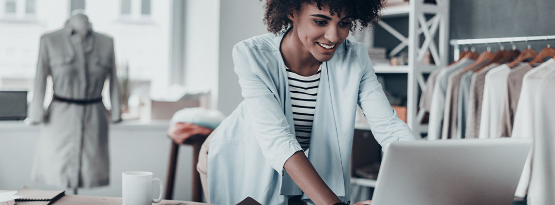 woman smiling at laptop screen