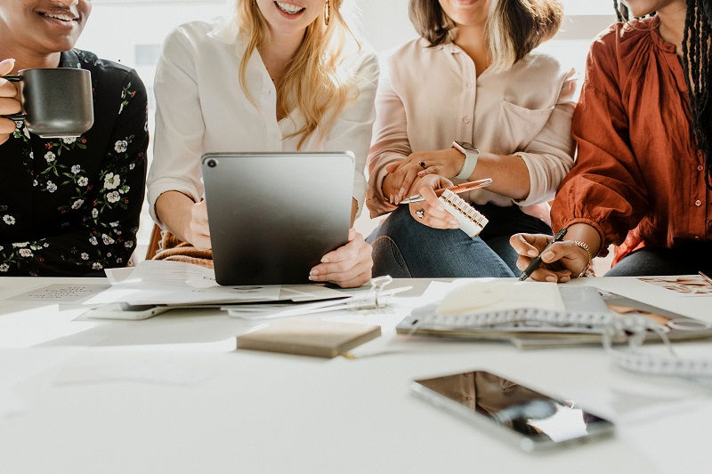 Fashion designers having a meeting using a digital tablet