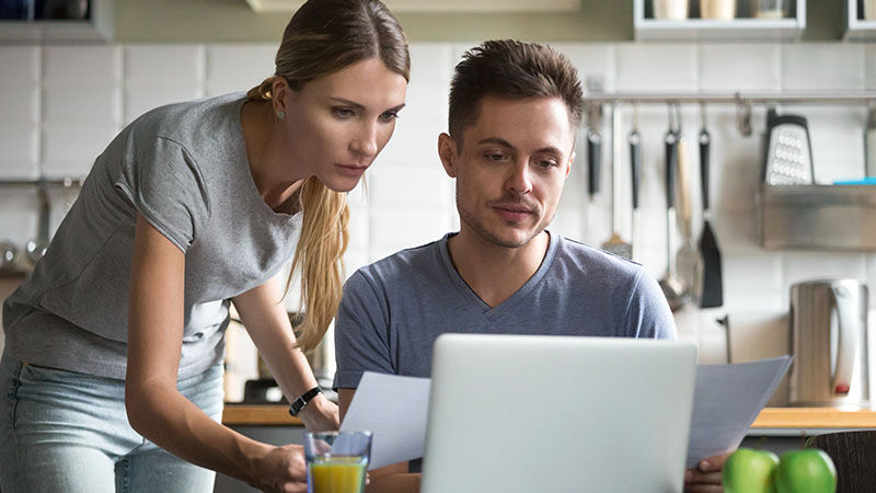 man and woman looking at laptop screen