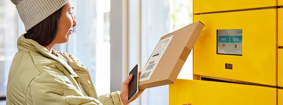 woman placing parcel in parcel locker