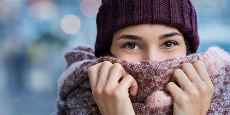 woman wearing a pink hat and scarf