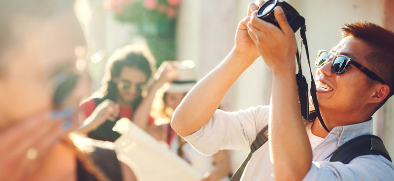 Man taking photograph in a street