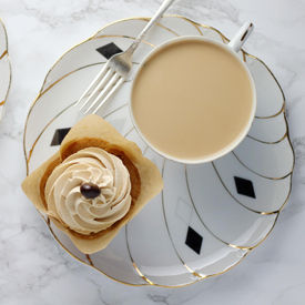 Cup of tea with a cake on a table