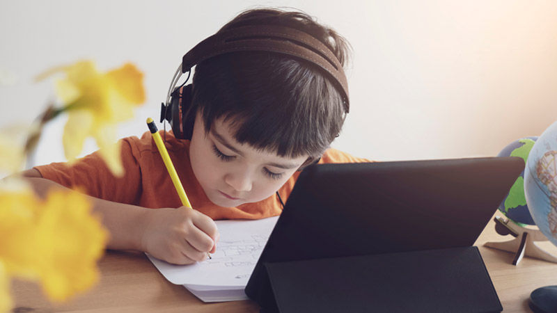 Boy doing homework at an iPad