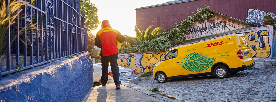 DHL courier walking away from van