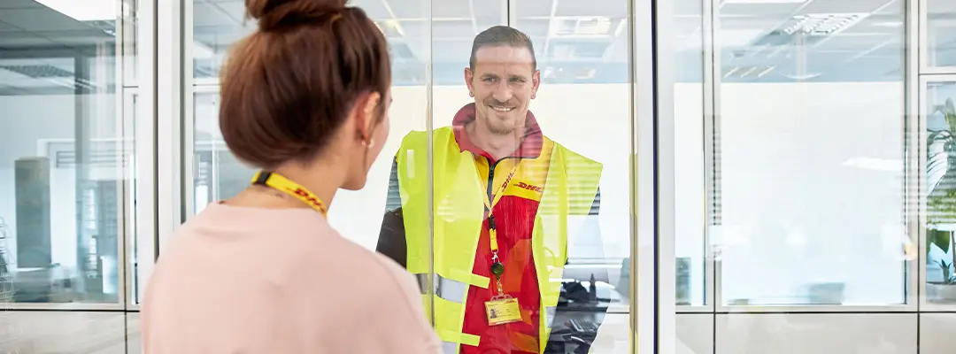 DHL courier smiling at customer