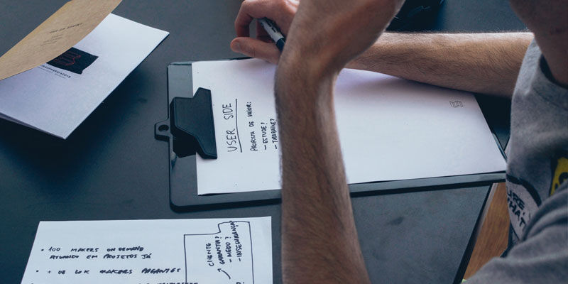 man writing at a desk