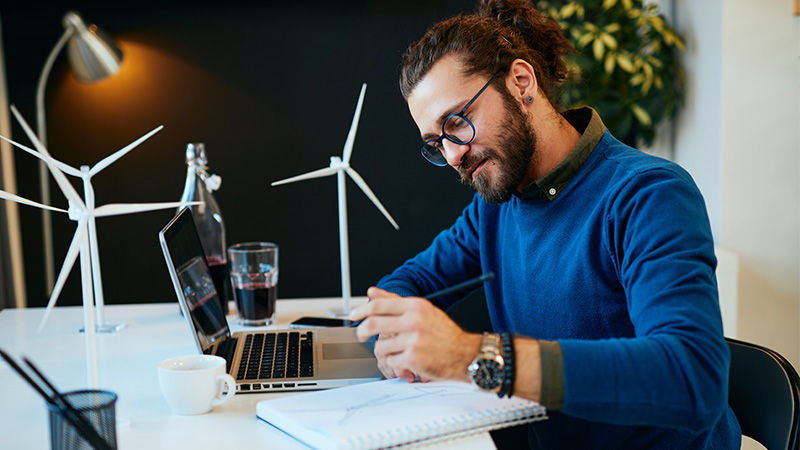 man typing on laptop