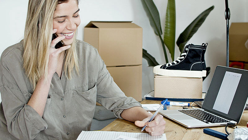 woman smiling holding a mobile phone