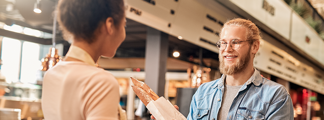 woman handing a man bread