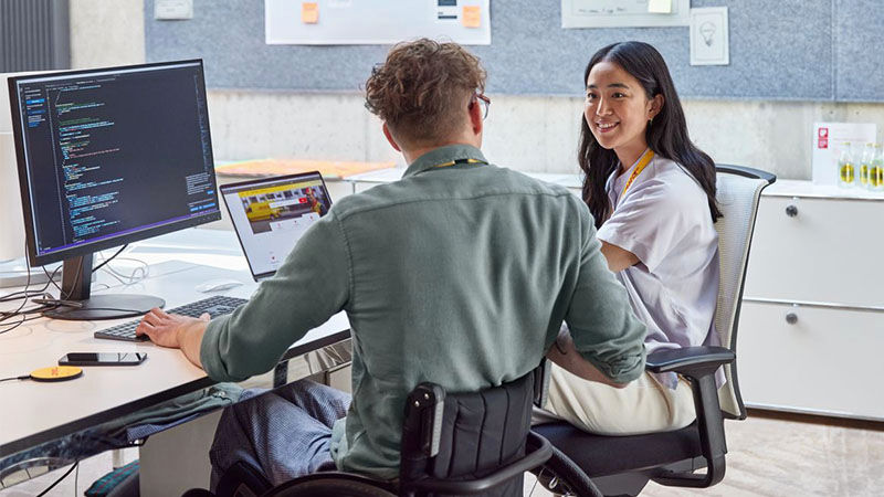 man and chatting in front of desk