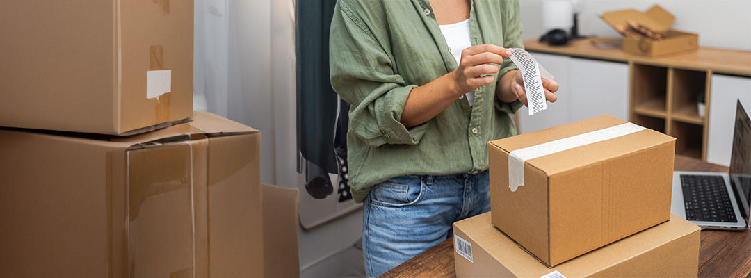 woman putting label on parcel