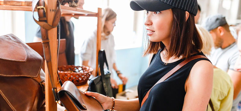 Woman looking at handbags in a shop