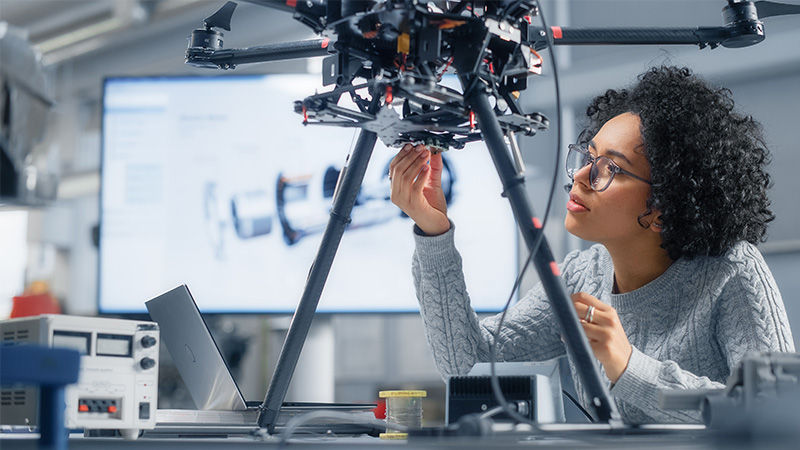 woman working on a robot