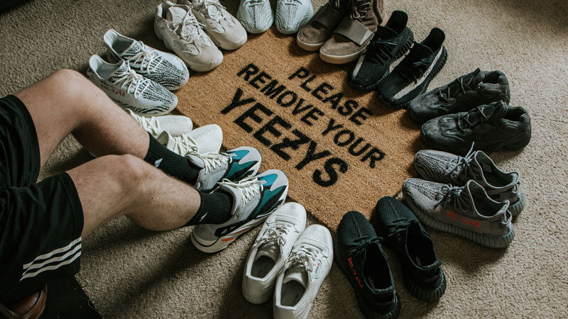 Collection of Yeezy shoes surrounding a doormat