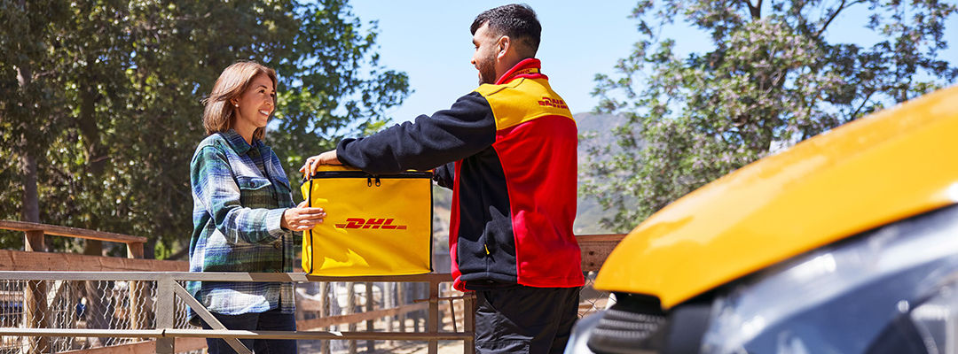 DHL courier handing woman a parcel