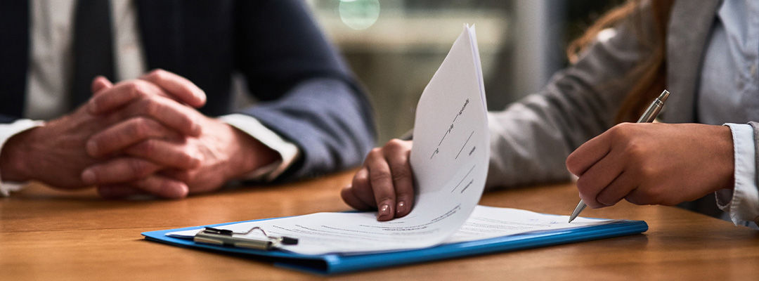 hand writing on clipboard 