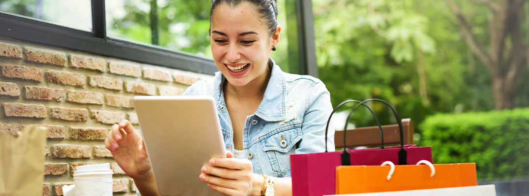 woman smiling at tablet screen