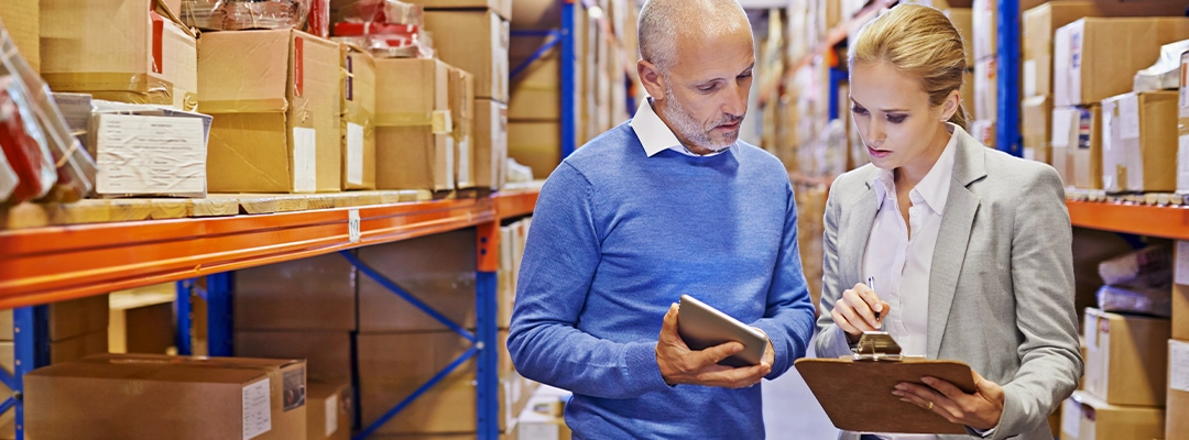 man and woman looking at tablet