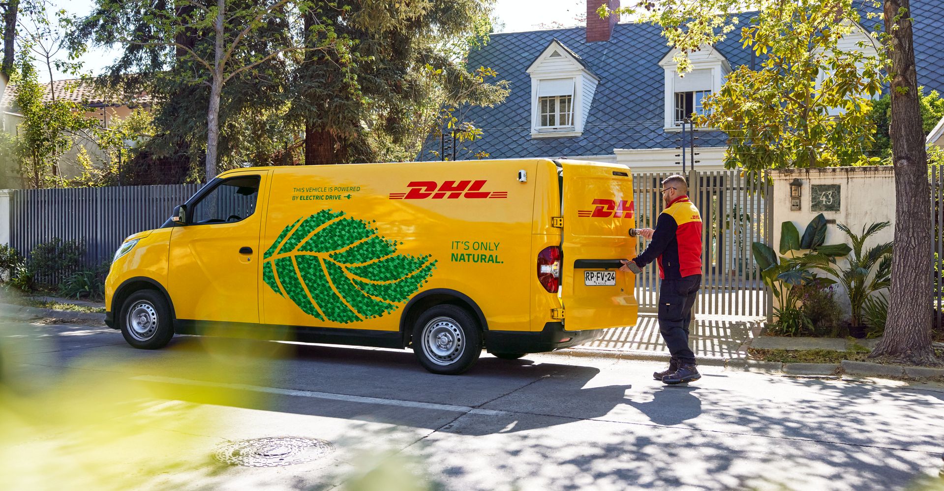  A DHL employee opening the van’s rear door