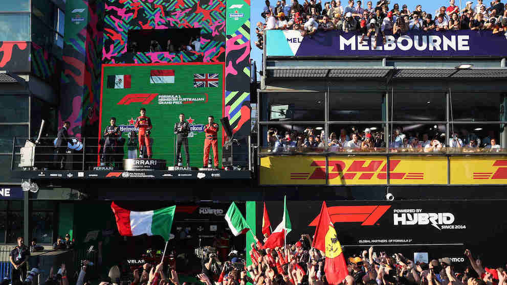 MELBOURNE GRAND PRIX CIRCUIT, AUSTRALIA - APRIL 10: Sergio Perez, Red Bull Racing, 2nd position, Charles Leclerc, Ferrari, 1st position, George Russell, Mercedes-AMG, 3rd position, and the Ferrari trophy delegate on the podium during the Australian GP at Melbourne Grand Prix Circuit on Sunday April 10, 2022 in Melbourne, Australia. (Photo by Glenn Dunbar / Motorsport Images / Adrivo)