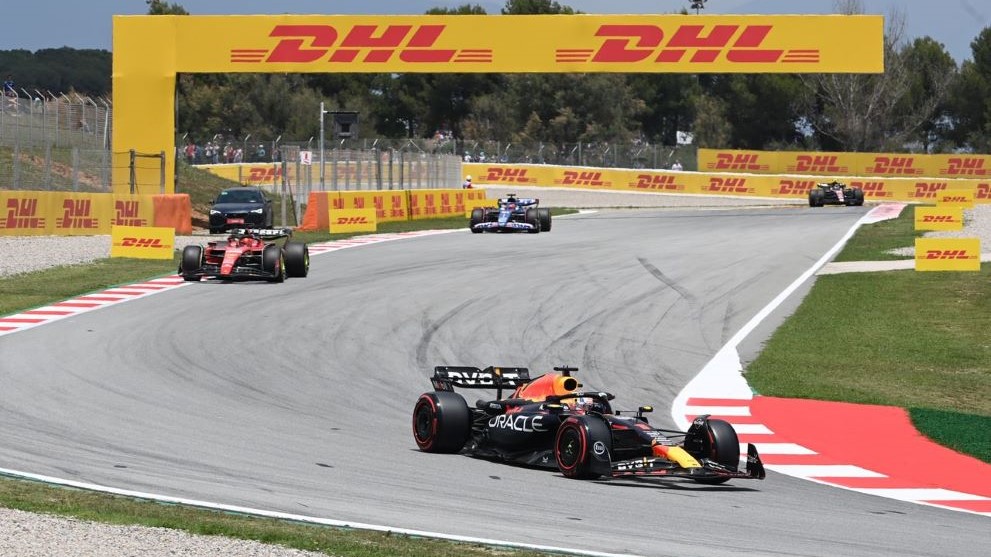 Formula 1® cars on track with DHL promotional banners overhead