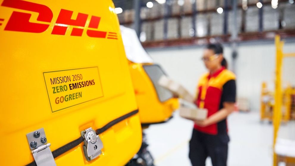 close up of dhl courier scooter with dhl gogreen green logistics information