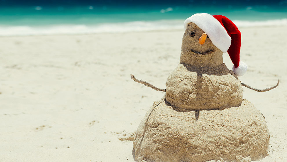 Snowman in a hat on a beach