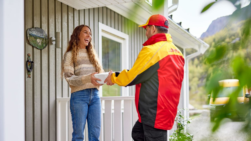 DHL courier handing a woman a parcel