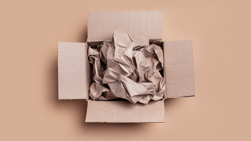 crumpled brown paper in a cardboard box