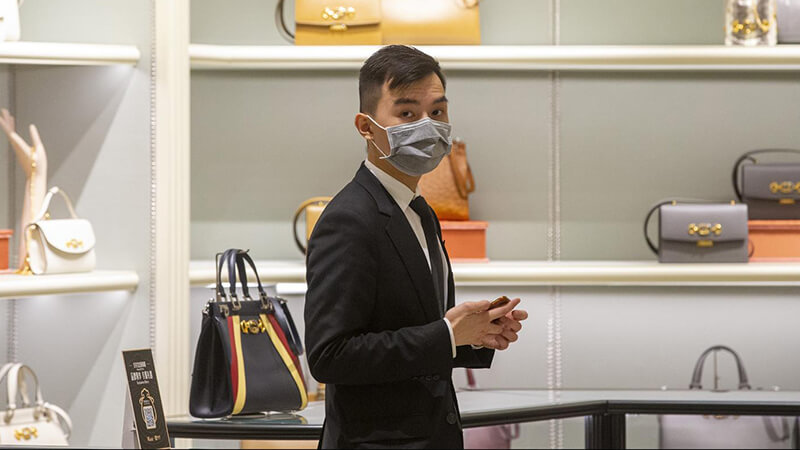 man in shop wearing a mask