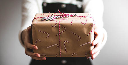 person holding wrapped Christmas present