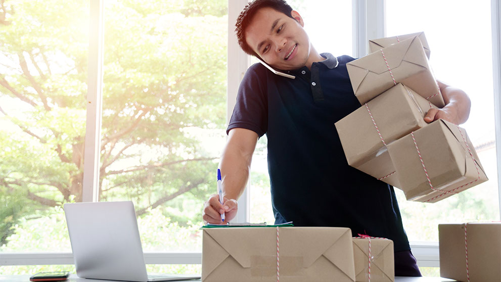 man holding brown packages