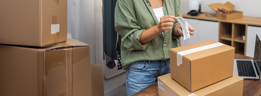 woman putting label on parcel