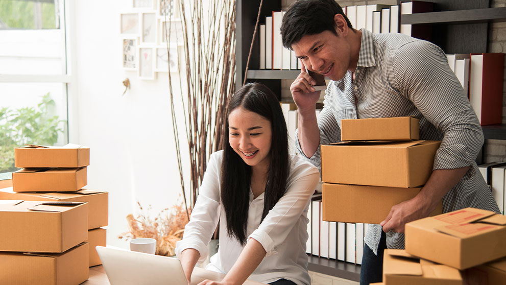 man and woman arranging brown packages