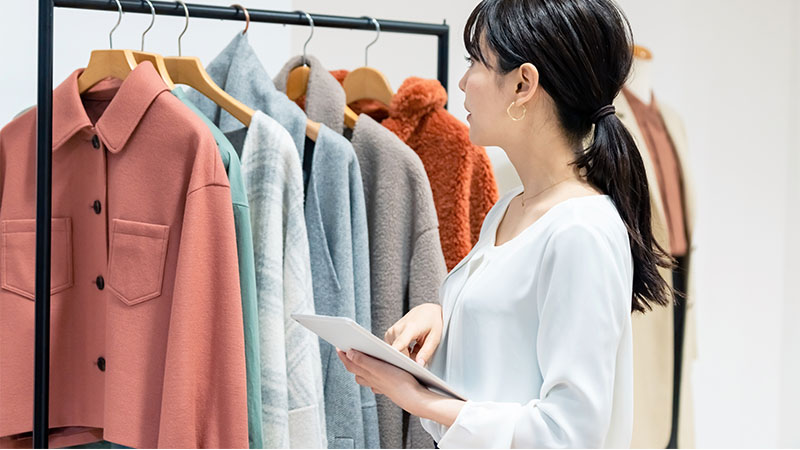 woman looking at clothes rack