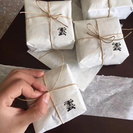 hand and white wrapped parcels