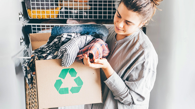 woman holding box with recyclable fabrics