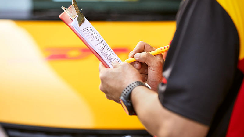 DHL courier holding clipboard