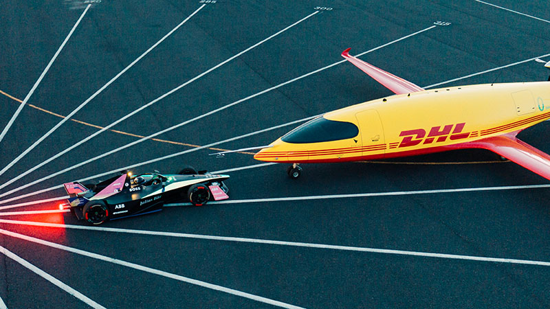 DHL airplane and formula e vehicle facing each other