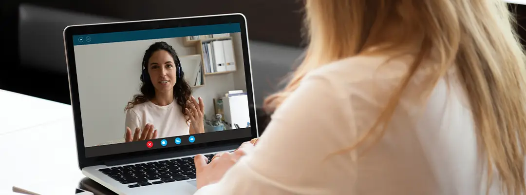woman talking to someone on a laptop screen